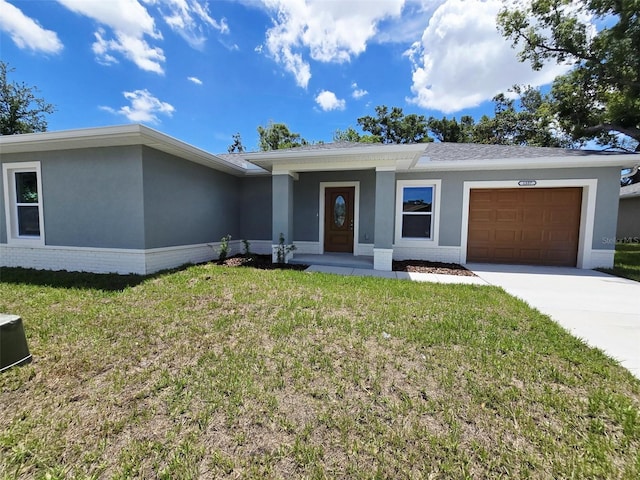 1557 S Martin Luther King Jr Ave, Clearwater, FL 33756 - view of front of home featuring stucco siding, an attached garage, driveway, and a front yard