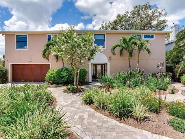 8 Sunset Bay Dr, Belleair, FL 33756 - view of front of property with stucco siding and an attached garage