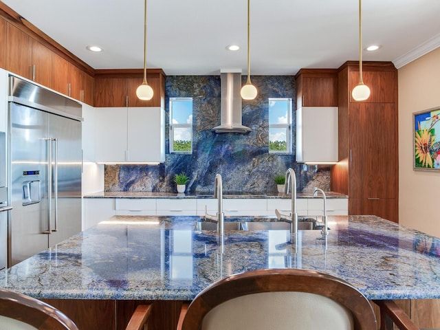 8 Sunset Bay Dr, Belleair, FL 33756 - kitchen with built in fridge, island range hood, backsplash, hanging light fixtures, and dark stone countertops
