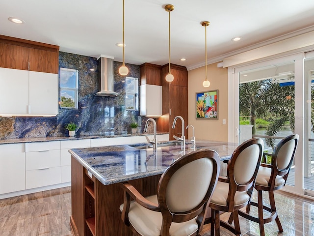 8 Sunset Bay Dr, Belleair, FL 33756 - kitchen featuring range hood, decorative backsplash, a kitchen breakfast bar, modern cabinets, and recessed lighting
