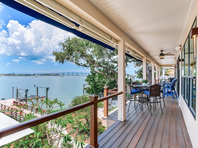 8 Sunset Bay Dr, Belleair, FL 33756 - wooden deck with a water view, outdoor dining space, and ceiling fan