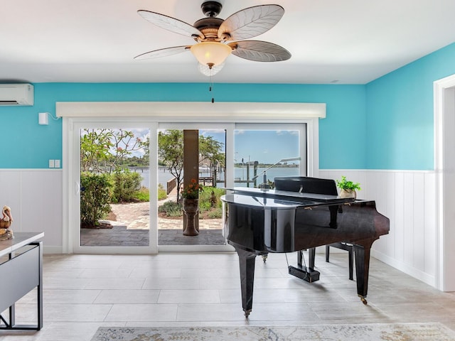 8 Sunset Bay Dr, Belleair, FL 33756 - living area with an AC wall unit, a wainscoted wall, and a ceiling fan