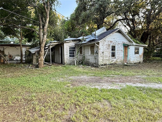 38408 C Ave, Zephyrhills, FL 33542 - back of house with stone siding and a lawn