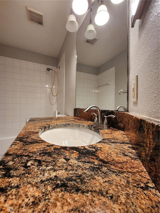 10539 Egret Haven Ln, Riverview, FL 33578 - full bath with vanity, a textured wall, and a shower