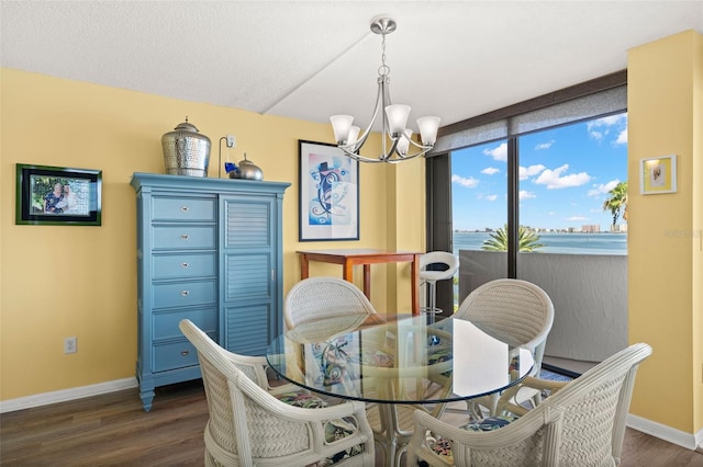 80 Rogers St Unit 3A, Clearwater, FL 33756 - dining area featuring dark wood-style flooring and a chandelier