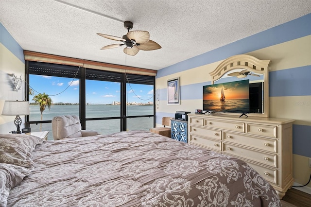80 Rogers St Unit 3A, Clearwater, FL 33756 - bedroom featuring access to exterior, a textured ceiling, and a ceiling fan