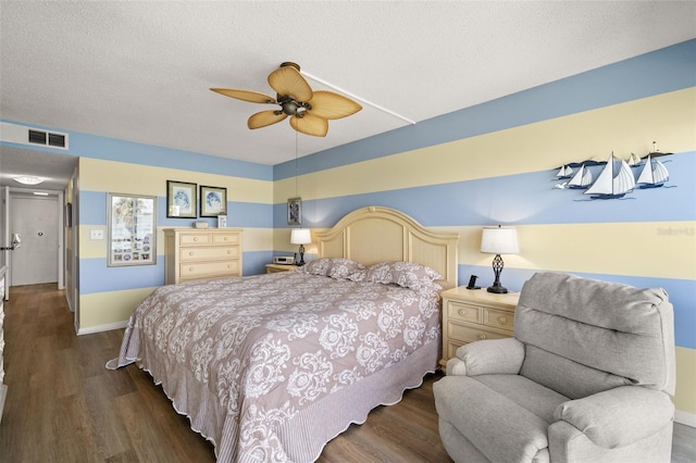 80 Rogers St Unit 3A, Clearwater, FL 33756 - bedroom featuring dark wood finished floors, a ceiling fan, and a textured ceiling