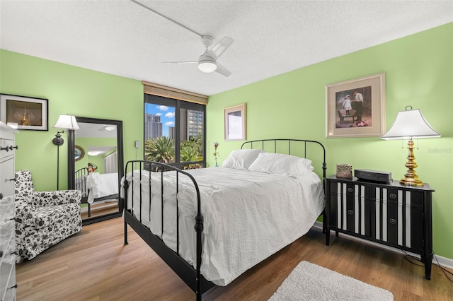 80 Rogers St Unit 3A, Clearwater, FL 33756 - bedroom featuring wood finished floors, a ceiling fan, and a textured ceiling