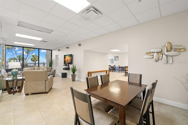 80 Rogers St Unit 3A, Clearwater, FL 33756 - dining space with a drop ceiling, light tile patterned flooring, and expansive windows