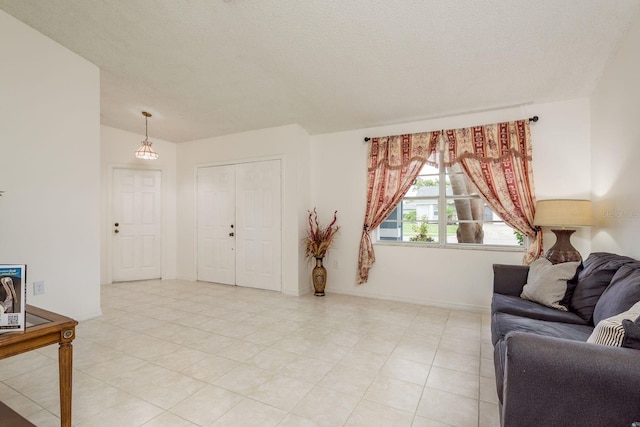 8629 Wolf Den Trl, Port Richey, FL 34668 - living area featuring a textured ceiling and light tile patterned floors