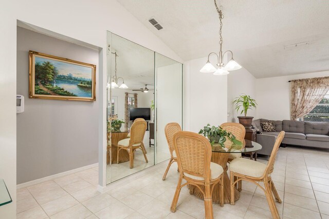 8629 Wolf Den Trl, Port Richey, FL 34668 - dining room with lofted ceiling, a chandelier, and light tile patterned flooring