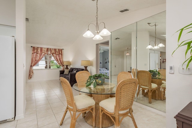 8629 Wolf Den Trl, Port Richey, FL 34668 - dining space with a chandelier, light tile patterned flooring, and vaulted ceiling