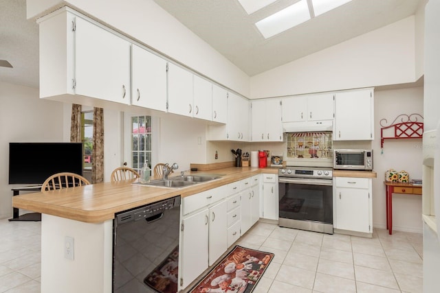 8629 Wolf Den Trl, Port Richey, FL 34668 - kitchen with appliances with stainless steel finishes, under cabinet range hood, light tile patterned flooring, light countertops, and white cabinetry
