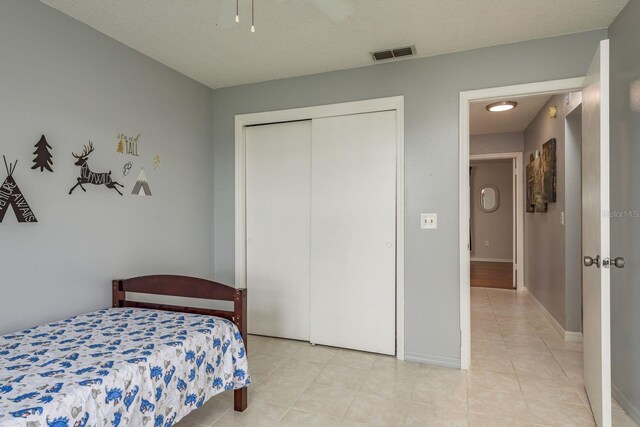 8629 Wolf Den Trl, Port Richey, FL 34668 - bedroom featuring a closet and light tile patterned floors