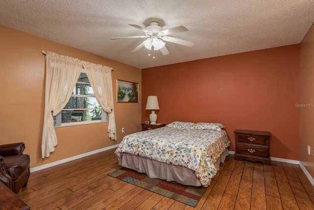 8629 Wolf Den Trl, Port Richey, FL 34668 - bedroom with wood-type flooring, a textured ceiling, and ceiling fan