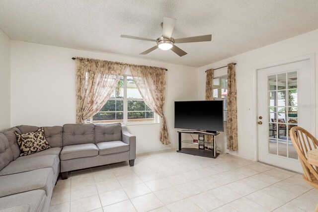 8629 Wolf Den Trl, Port Richey, FL 34668 - living area featuring ceiling fan, a textured ceiling, and light tile patterned flooring