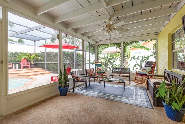 8629 Wolf Den Trl, Port Richey, FL 34668 - sunroom / solarium featuring healthy amount of natural light, a ceiling fan, an outdoor hangout area, and beamed ceiling