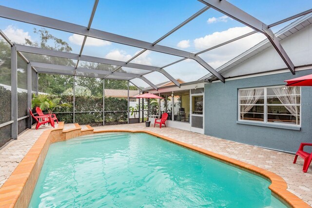 8629 Wolf Den Trl, Port Richey, FL 34668 - view of swimming pool with a patio area and a lanai