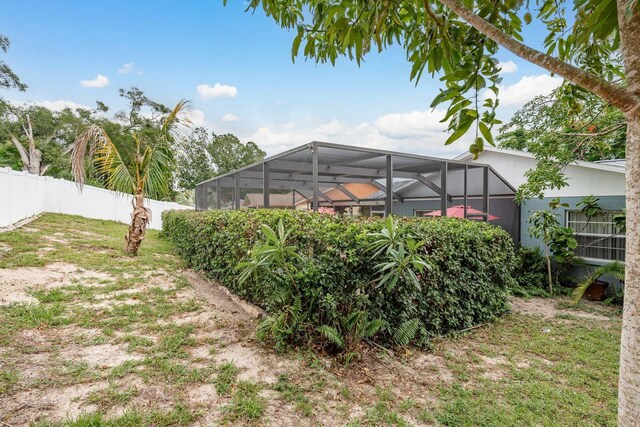 8629 Wolf Den Trl, Port Richey, FL 34668 - view of yard featuring a lanai