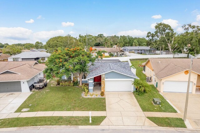 8629 Wolf Den Trl, Port Richey, FL 34668 - ranch-style home featuring a residential view, a front yard, a garage, and concrete driveway
