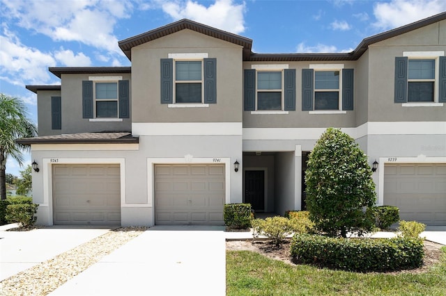 9741 Mulberry Marsh Ln, Sun City Center, FL 33573 - view of property with an attached garage, stucco siding, and driveway