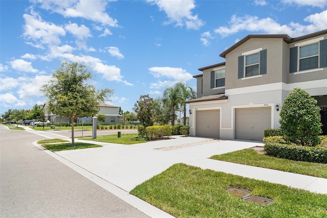 9741 Mulberry Marsh Ln, Sun City Center, FL 33573 - view of side of home featuring stucco siding, driveway, and an attached garage
