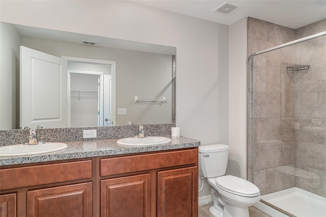 9741 Mulberry Marsh Ln, Sun City Center, FL 33573 - bathroom featuring double vanity, a stall shower, and a spacious closet