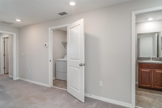 9741 Mulberry Marsh Ln, Sun City Center, FL 33573 - unfurnished bedroom featuring washer / clothes dryer, light carpet, recessed lighting, and ensuite bath
