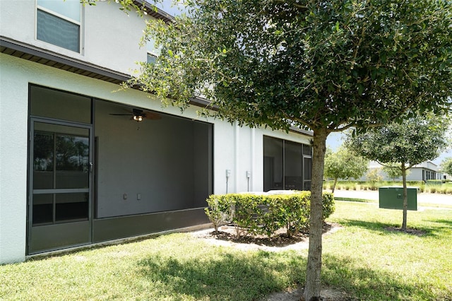 9741 Mulberry Marsh Ln, Sun City Center, FL 33573 - view of green lawn featuring a sunroom and a ceiling fan