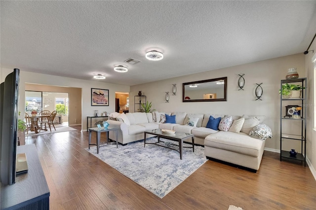 1502 Fort Duquesna Dr, Sun City Center, FL 33573 - living area featuring wood finished floors and a textured ceiling