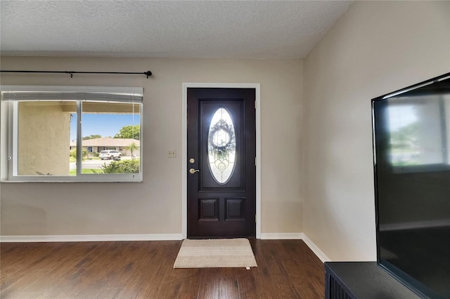 1502 Fort Duquesna Dr, Sun City Center, FL 33573 - entrance foyer featuring dark wood-style flooring and a textured ceiling