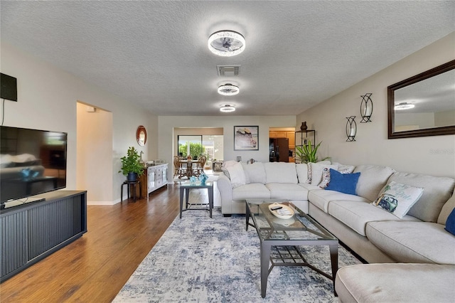 1502 Fort Duquesna Dr, Sun City Center, FL 33573 - living area with wood finished floors and a textured ceiling