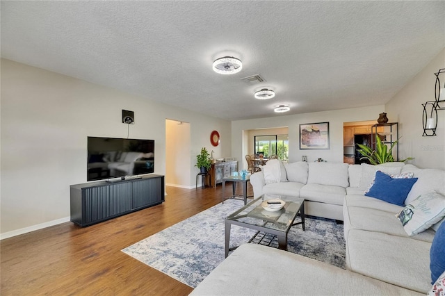 1502 Fort Duquesna Dr, Sun City Center, FL 33573 - living area with wood finished floors and a textured ceiling