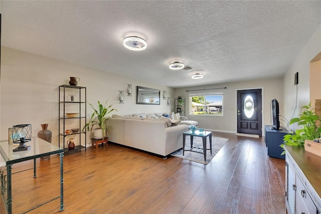 1502 Fort Duquesna Dr, Sun City Center, FL 33573 - living area featuring dark wood-style floors and a textured ceiling