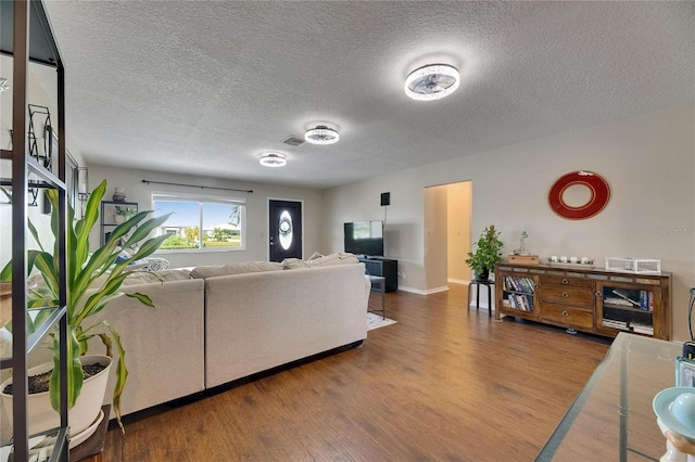 1502 Fort Duquesna Dr, Sun City Center, FL 33573 - living area featuring wood finished floors and a textured ceiling