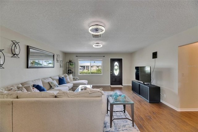 1502 Fort Duquesna Dr, Sun City Center, FL 33573 - living room with wood finished floors and a textured ceiling