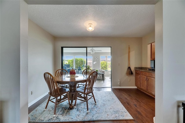 1502 Fort Duquesna Dr, Sun City Center, FL 33573 - dining room with dark wood-style flooring, a textured ceiling, and ceiling fan