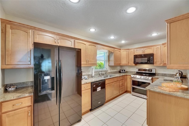 1502 Fort Duquesna Dr, Sun City Center, FL 33573 - kitchen with black appliances, a textured ceiling, recessed lighting, light brown cabinets, and light stone countertops