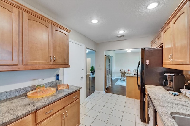 1502 Fort Duquesna Dr, Sun City Center, FL 33573 - kitchen featuring a textured ceiling, light tile patterned floors, light stone counters, recessed lighting, and stainless steel dishwasher