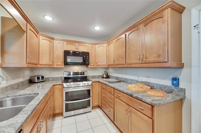 1502 Fort Duquesna Dr, Sun City Center, FL 33573 - kitchen with black microwave, double oven range, light tile patterned flooring, light stone counters, and a textured ceiling