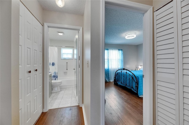1502 Fort Duquesna Dr, Sun City Center, FL 33573 - corridor featuring wood finished floors and a textured ceiling
