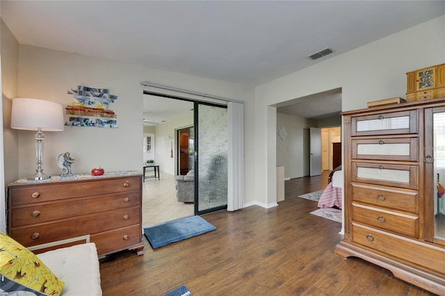 1502 Fort Duquesna Dr, Sun City Center, FL 33573 - bedroom featuring dark wood-type flooring and access to exterior