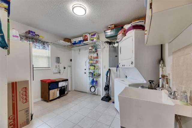 1502 Fort Duquesna Dr, Sun City Center, FL 33573 - laundry room featuring stacked washing machine and dryer, a textured ceiling, electric panel, and light tile patterned floors