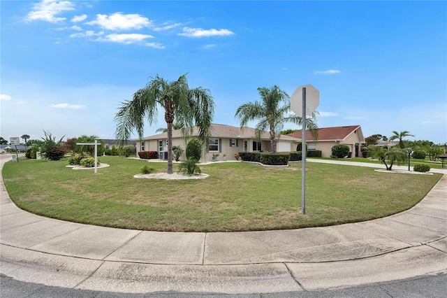 1502 Fort Duquesna Dr, Sun City Center, FL 33573 - view of front of house featuring a front lawn, stucco siding, and driveway