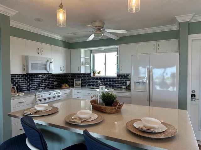 1365 Snell Isle Blvd NE Unit 6E, Saint Petersburg, FL 33704 - kitchen with white appliances, a breakfast bar, pendant lighting, backsplash, and a ceiling fan