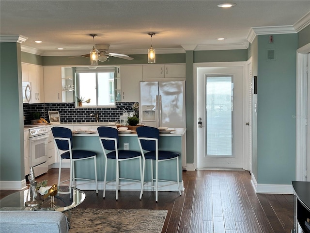 1365 Snell Isle Blvd NE Unit 6E, Saint Petersburg, FL 33704 - kitchen featuring white appliances, a ceiling fan, healthy amount of natural light, light countertops, and ornamental molding