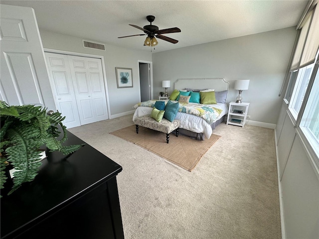 1365 Snell Isle Blvd NE Unit 6E, Saint Petersburg, FL 33704 - bedroom with carpet floors, a closet, a ceiling fan, and a textured ceiling