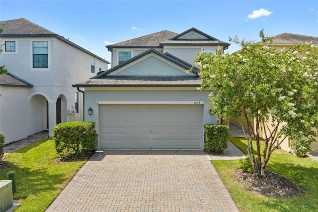 1604 Acadia Harbor Pl, Brandon, FL 33511 - view of front facade with stucco siding, decorative driveway, a front lawn, and an attached garage