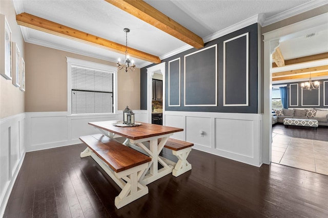 1604 Acadia Harbor Pl, Brandon, FL 33511 - dining room featuring a chandelier, a decorative wall, beam ceiling, dark wood finished floors, and wainscoting