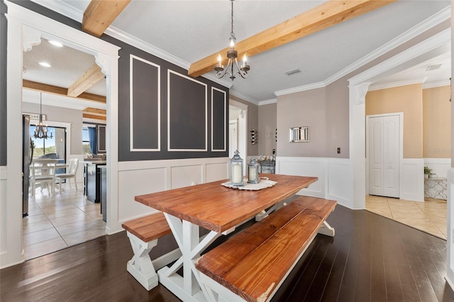 1604 Acadia Harbor Pl, Brandon, FL 33511 - dining room with a chandelier, beam ceiling, hardwood / wood-style floors, a decorative wall, and a wainscoted wall